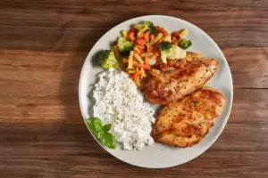 barbecue chicken with rice and veggies is a delicious large family dinner idea.