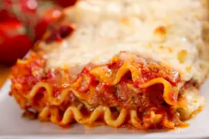 homemade lasagna is one of the best homemade large family dinner ideas as it's simple ingredients are filling and comforting.
