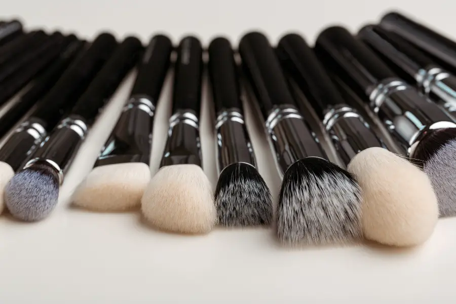 a row of makeup brushes used to blend the best non-toxic concealer.